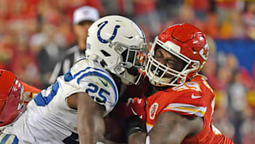 KANSAS CITY, MO - OCTOBER 06: Defensive tackle Khalen Saunders #99 of the Kansas City Chiefs tackles running back Marlon Mack #25 of the Indianapolis Colts during the second half at Arrowhead Stadium on October 6, 2019 in Kansas City, Missouri. (Photo by Peter Aiken/Getty Images)