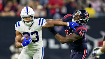 HOUSTON, TX - NOVEMBER 21: Jonathan Williams #33 of the Indianapolis Colts stiff arms Zach Cunningham #41 of the Houston Texans at NRG Stadium on November 21, 2019 in Houston, Texas. The Texans defeated the Colts 20-17. (Photo by Wesley Hitt/Getty Images)