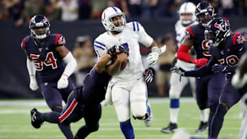 HOUSTON, TX - NOVEMBER 21: Jacoby Brissett #7 of the Indianapolis Colts is tackled on fourth down by Brennan Scarlett #57 of the Houston Texans in the fourth quarter at NRG Stadium on November 21, 2019 in Houston, Texas. (Photo by Tim Warner/Getty Images)