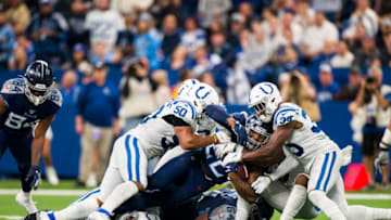 INDIANAPOLIS, IN - DECEMBER 01: Derrick Henry #22 of the Tennessee Titans pushes against Indianapolis Colts defenders as he carries the ball during the fourth quarter at Lucas Oil Stadium on December 1, 2019 in Indianapolis, Indiana. Tennessee defeats Indianapolis 31-17. (Photo by Brett Carlsen/Getty Images)