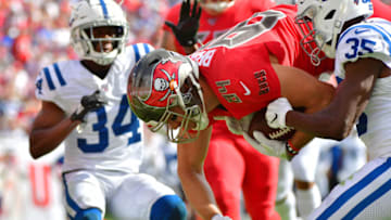 TAMPA, FLORIDA - DECEMBER 08: Cameron Brate #84 of the Tampa Bay Buccaneers catches a 13-yard reception over Pierre Desir #35 of the Indianapolis Colts in the first quarter of a football game at Raymond James Stadium on December 08, 2019 in Tampa, Florida. (Photo by Julio Aguilar/Getty Images)