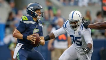 SEATTLE, WA - AUGUST 09: Quarterback Austin Davis #6 of the Seattle Seahawks scrambles under pressure from defensive end Denico Autry #95 of the Indianapolis Colts at CenturyLink Field on August 9, 2018 in Seattle, Washington. (Photo by Otto Greule Jr/Getty Images)