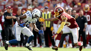 LANDOVER, MD - SEPTEMBER 16: T.Y. Hilton #13 of the Indianapolis Colts is tackled by Quinton Dunbar #23 of the Washington Redskins after catching a pass at FedExField on September 16, 2018 in Landover, Maryland. (Photo by Rob Carr/Getty Images)