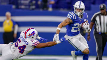 INDIANAPOLIS, IN - OCTOBER 21: Jordan Wilkins #20 of the Indianapolis Colts runs the ball as Eddie Yarbrough #54 of the Buffalo Bills reaches for the tackle at Lucas Oil Stadium on October 21, 2018 in Indianapolis, Indiana. (Photo by Michael Hickey/Getty Images)