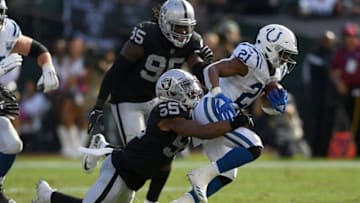 OAKLAND, CA - OCTOBER 28: Nyheim Hines #21 of the Indianapolis Colts carries the ball and gets tackled from behind by Marquel Lee #55 of the Oakland Raiders during the second half of their NFL football game at Oakland-Alameda County Coliseum on October 28, 2018 in Oakland, California. (Photo by Thearon W. Henderson/Getty Images)