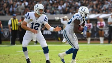 OAKLAND, CA - OCTOBER 28: Andrew Luck #12 of the Indianapolis Colts hands off to Marlon Mack #25 whoe scores on a one yard run against the Oakland Raiders during the second half of their NFL football game at Oakland-Alameda County Coliseum on October 28, 2018 in Oakland, California. (Photo by Thearon W. Henderson/Getty Images)