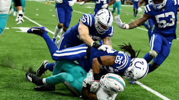 INDIANAPOLIS, INDIANA - NOVEMBER 25: Clayton Geathers #26 of the Indianapolis Colts tackles Kalen Ballage #27 of the Miami Dolphins in the second quarter at Lucas Oil Stadium on November 25, 2018 in Indianapolis, Indiana. (Photo by Stacy Revere/Getty Images)