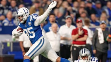 INDIANAPOLIS, IN - DECEMBER 16: Eric Ebron #85 of the Indianapolis Colts runs the ball as Chidobe Awuzie #24 of the Dallas Cowboys tries to make the shoestring tackle during the game at Lucas Oil Stadium on December 16, 2018 in Indianapolis, Indiana. (Photo by Michael Hickey/Getty Images)