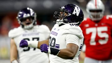 INDIANAPOLIS, INDIANA - DECEMBER 01: Jordan Thompson #99 of the Northwestern Wildcats reacts after a sack against the Ohio State Buckeyes in the fourth quarter at Lucas Oil Stadium on December 01, 2018 in Indianapolis, Indiana. (Photo by Joe Robbins/Getty Images)