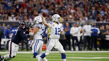 HOUSTON, TX - JANUARY 05: Andrew Luck #12 of the Indianapolis Colts throws the ball pressured by Whitney Mercilus #59 of the Houston Texans in the second quarter during the Wild Card Round at NRG Stadium on January 5, 2019 in Houston, Texas. (Photo by Bob Levey/Getty Images)