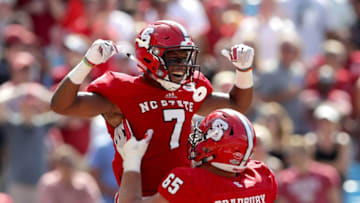 CHARLOTTE, NC - SEPTEMBER 02: Nyheim Hines #7 and teammate Garrett Bradbury #65 of the North Carolina State Wolfpack celebrate after Hines scores a touchdown against the South Carolina Gamecocks during their game at Bank of America Stadium on September 2, 2017 in Charlotte, North Carolina. (Photo by Streeter Lecka/Getty Images)