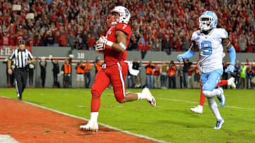 RALEIGH, NC - NOVEMBER 25: Nyheim Hines #7 of the North Carolina State Wolfpack scores on a long run against the North Carolina Tar Heels during their game at Carter Finley Stadium on November 25, 2017 in Raleigh, North Carolina. North Carolina State won 33-21. (Photo by Grant Halverson/Getty Images)