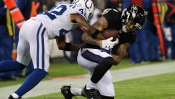 BALTIMORE, MD - DECEMBER 23: Wide Receiver Chris Moore #10 of the Baltimore Ravens catches the ball as he is tackled by defensive back Kenny Moore #42 of the Indianapolis Colts in the second quarter at M&T Bank Stadium on December 23, 2017 in Baltimore, Maryland. (Photo by Rob Carr/Getty Images)