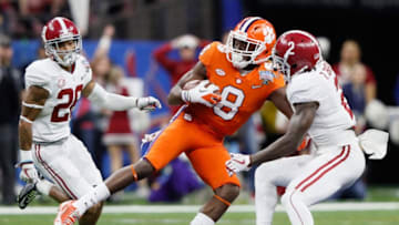NEW ORLEANS, LA - JANUARY 01: Deon Cain #8 of the Clemson Tigers runs with the ball as Tony Brown #2 of the Alabama Crimson Tide and Anthony Averett #28 defend in the first half of the AllState Sugar Bowl at the Mercedes-Benz Superdome on January 1, 2018 in New Orleans, Louisiana. (Photo by Jamie Squire/Getty Images)