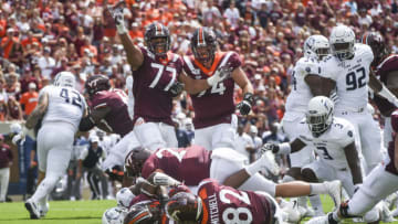 BLACKSBURG, VA - SEPTEMBER 07: Offensive lineman Christian Darrisaw #77 and offensive lineman Doug Nester #74 of the Virginia Tech Hokies celebrate a touchdown run by running back Keshawn King #35 against the Old Dominion Monarchs in the first half at Lane Stadium on September 7, 2019 in Blacksburg, Virginia. (Photo by Michael Shroyer/Getty Images)