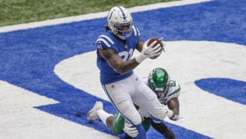 INDIANAPOLIS, IN - SEPTEMBER 27: Mo Alie-Cox #81 of the Indianapolis Colts makes a touchdown reception as Tarell Basham #93 of the New York Jets defends during the first half at Lucas Oil Stadium on September 27, 2020 in Indianapolis, Indiana. (Photo by Michael Hickey/Getty Images)