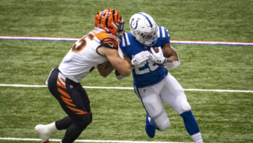 INDIANAPOLIS, IN - OCTOBER 18: Jonathan Taylor #28 of the Indianapolis Colts is pushed out of bounds by Logan Wilson #55 of the Cincinnati Bengals during the first quarter of the game at Lucas Oil Stadium on October 18, 2020 in Indianapolis, Indiana. (Photo by Bobby Ellis/Getty Images)