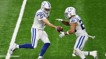 DETROIT, MICHIGAN - NOVEMBER 01: Philip Rivers #17 of the Indianapolis Colts hands the ball off to Jordan Wilkins #20 during the fourth quarter at Ford Field on November 01, 2020 in Detroit, Michigan. (Photo by Nic Antaya/Getty Images)
