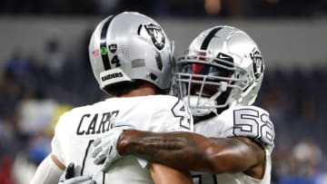 INGLEWOOD, CALIFORNIA - OCTOBER 04: Derek Carr #4 and Denzel Perryman #52 of the Las Vegas Raiders warm up before the game against the Los Angeles Chargers at SoFi Stadium on October 04, 2021 in Inglewood, California. (Photo by Katelyn Mulcahy/Getty Images)