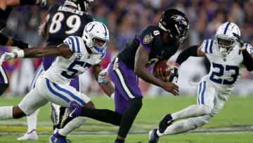 BALTIMORE, MARYLAND - OCTOBER 11: Lamar Jackson #8 of the Baltimore Ravens is tackled by Darius Leonard #53 and Kenny Moore II #23 of the Indianapolis Colts during the first quarter in a game at M&T Bank Stadium on October 11, 2021 in Baltimore, Maryland. (Photo by Rob Carr/Getty Images)