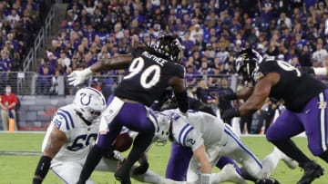 Oct 11, 2021; Baltimore, Maryland, USA; Indianapolis Colts quarterback Carson Wentz (2) fumbles the ball after being hit by Baltimore Ravens outside linebacker Odafe Oweh (99) during the first quarter at M&T Bank Stadium. Mandatory Credit: Geoff Burke-USA TODAY Sports