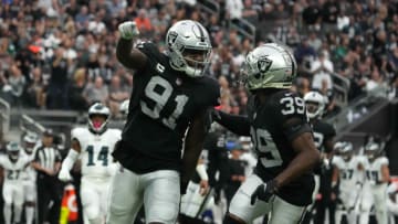 Oct 24, 2021; Paradise, Nevada, USA; Las Vegas Raiders defensive end Yannick Ngakoue (91) celebrates with cornerback Nate Hobbs (39) against the Philadelphia Eagles in the first half at Allegiant Stadium. Mandatory Credit: Kirby Lee-USA TODAY Sports