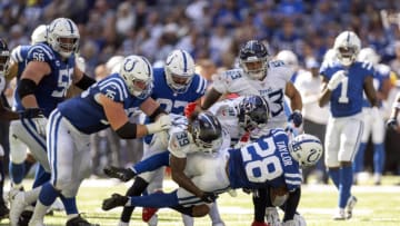 Oct 2, 2022; Indianapolis, Indiana, USA; Indianapolis Colts running back Jonathan Taylor (28) is tackled by multiple Tennessee Titans during the second half at Lucas Oil Stadium. Titans won 24 to 17. Mandatory Credit: Marc Lebryk-USA TODAY Sports