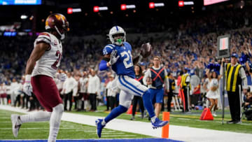 Indianapolis Colts running back Nyheim Hines (21) runs the ball in ahead of Washington Commanders cornerback Kendall Fuller (29) for a touchdown Sunday, Oct. 30, 2022, during a game against the Washington Commanders at Indianapolis Colts at Lucas Oil Stadium in Indianapolis.