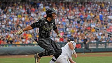 OMAHA, NE - JUNE 25: Austin Martin #16 of the Vanderbilt Commodores gets thrown out at first base in the third inning against the Michigan Wolverines during game two of the College World Series Championship Series on June 25, 2019 at TD Ameritrade Park Omaha in Omaha, Nebraska. (Photo by Peter Aiken/Getty Images)