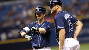 ST. PETERSBURG, FL - JULY 5: Nick Franklin #2 of the Tampa Bay Rays stands next to first base coach Rocco Baldelli #15 as he gestures back to the dugout after hitting a two-run single during the fifth inning of a game against the Los Angeles Angels of Anaheim on July 5, 2016 at Tropicana Field in St. Petersburg, Florida. (Photo by Brian Blanco/Getty Images)