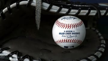 KANSAS CITY, MO - MARCH 29: A ball sits in a glove in the dugout prior to the game between the Chicago White Sox and the Kansas City Royals on Opening Day at Kauffman Stadium on March 29, 2018 in Kansas City, Missouri. (Photo by Jamie Squire/Getty Images)