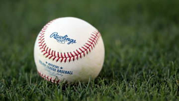 LOS ANGELES, CA - MAY 04: A Major League baseball rests on the grass prior to the start of the game between the Milwaukee Brewers and the Los Angeles Dodgers at Dodger Stadium on May 4, 2010 in Los Angeles, California. (Photo by Jeff Gross/Getty Images)
