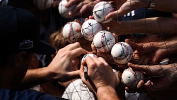 LONDON, ENGLAND - JUNE 28: Baseball fans hold out baseballs to be signed at The London Stadium on June 28, 2019 in London, England. The New York Yankees are playing the Boston Red Sox this weekend in the first Major League Baseball game to be held in Europe. (Photo by Peter Summers/Getty Images)