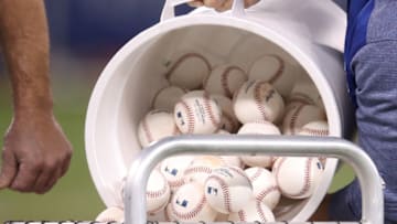 TORONTO, ON - MAY 10: A bucket full of baseballs is dumped into the pitching basket during batting practice before the start of the Toronto Blue Jays MLB game against the Seattle Mariners at Rogers Centre on May 10, 2018 in Toronto, Canada. (Photo by Tom Szczerbowski/Getty Images) *** Local Caption ***