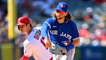 May 29, 2022; Anaheim, California, USA; Los Angeles Angels designated hitter Shohei Ohtani (17) breaks up a double play as Toronto Blue Jays shortstop Bo Bichette (11) throws to first in the sixth inning of the game at Angel Stadium. Mandatory Credit: Jayne Kamin-Oncea-USA TODAY Sports