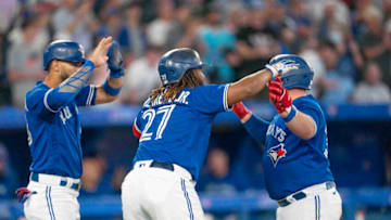 Aug 31, 2022; Toronto, Ontario, CAN; Toronto Blue Jays catcher Alejandro Kirk (30) celebrates after hitting a three run home run with Toronto Blue Jays designated hitter Vladimir Guerrero Jr. (27) and Toronto Blue Jays left fielder Lourdes Gurriel Jr. (13) against the Chicago Cubs during the sixth inning at Rogers Centre. Mandatory Credit: Nick Turchiaro-USA TODAY Sports