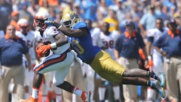 September 5, 2015; Pasadena, CA, USA; Virginia Cavaliers running back Olamide Zaccheaus (33) runs the ball against the defense of UCLA Bruins linebacker Myles Jack (30) during the first half at the Rose Bowl. Mandatory Credit: Gary A. Vasquez-USA TODAY Sports