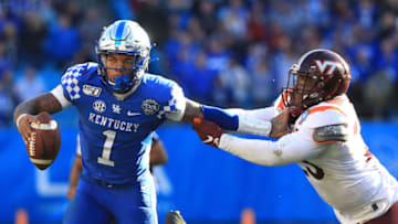 CHARLOTTE, NORTH CAROLINA - DECEMBER 31: Rayshard Ashby #23 of the Virginia Tech Hokies tries to stop Lynn Bowden Jr. #1 of the Kentucky Wildcats as he runs with the ball during the Belk Bowl at Bank of America Stadium on December 31, 2019 in Charlotte, North Carolina. (Photo by Streeter Lecka/Getty Images)
