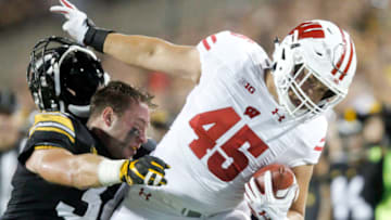 IOWA CITY, IOWA- SEPTEMBER 22: Fullback Alec Ingold #45 of the Wisconsin Badgers breaks a tackle in the first half by linebacker Kristian Welch #34 of the Iowa Hawkeyes on September 22, 2018 at Kinnick Stadium, in Iowa City, Iowa. (Photo by Matthew Holst/Getty Images)