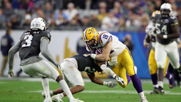 GLENDALE, ARIZONA - JANUARY 01: Defensive back Rashard Causey #21 of the UCF Knights tackles tight end Foster Moreau #18 of the LSU Tigers during the third quarter of the PlayStation Fiesta Bowl between LSU and Central Florida at State Farm Stadium on January 01, 2019 in Glendale, Arizona. (Photo by Christian Petersen/Getty Images)