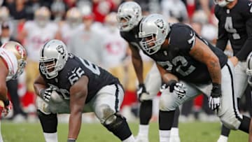 OAKLAND, CA - DECEMBER 7: Guard Gabe Jackson No. 66 and tackle Donald Penn No. 72 of the Oakland Raiders prepare to block on a play against the San Francisco 49ers in the fourth quarter on December 7, 2014 at O.co Coliseum in Oakland, California. The Raiders won 24-13. (Photo by Brian Bahr/Getty Images)