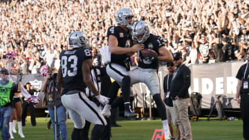 OAKLAND, CALIFORNIA - NOVEMBER 03: Hunter Renfrow #13 and Derek Carr #4 of the Oakland Raiders celebrates after Renfrow caught a touchdown pass from Carr against the Detroit Lions during the fourth quarter of an NFL football game at RingCentral Coliseum on November 03, 2019 in Oakland, California. The Raiders won the game 31-24. (Photo by Thearon W. Henderson/Getty Images)