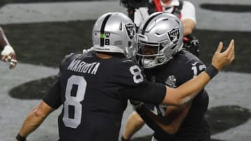 LAS VEGAS, NEVADA - DECEMBER 17: Quarterback Marcus Mariota #8 and wide receiver Zay Jones #12 of the Las Vegas Raiders celebrate after Mariota ran for a 2-yard touchdown against the Los Angeles Chargers in the second half of their game at Allegiant Stadium on December 17, 2020 in Las Vegas, Nevada. The Chargers defeated the Raiders 30-27 in overtime. (Photo by Ethan Miller/Getty Images)