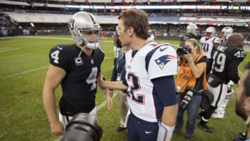 MEXICO CITY, MEXICO - NOVEMBER 19: Quarterback Tom Brady #12 of the New England Patriots and quarterback Derek Carr #4 of the Oakland Raiders shake hands at Estadio Azteca on November 19, 2017 in Mexico City, Mexico. (Photo by Jamie Schwaberow/Getty Images)