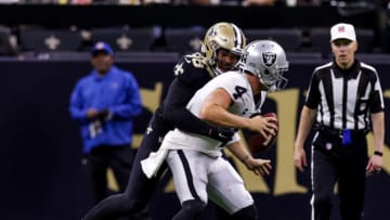 Oct 30, 2022; New Orleans, Louisiana, USA; Las Vegas Raiders quarterback Derek Carr (4) is sacked by New Orleans Saints defensive end Payton Turner (98) during the second half at Caesars Superdome. Mandatory Credit: Stephen Lew-USA TODAY Sports