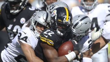 Sep 19, 2021; Pittsburgh, Pennsylvania, USA; Pittsburgh Steelers running back Najee Harris (22) is tackled by Las Vegas Raiders defensive back Johnathan Abram (24) and cornerback Damon Arnette (right) during the fourth quarter at Heinz Field. Las Vegas won 26-17. Mandatory Credit: Charles LeClaire-USA TODAY Sports