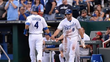 Jun 7, 2014; Kansas City, MO, USA; Kansas City Royals left fielder Alex Gordon (4) is congratulated by third baseman Mike Moustakas (8) after Gordon scores in the second inning against the New York Yankees at Kauffman Stadium. Mandatory Credit: Denny Medley-USA TODAY Sports