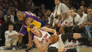 Nov 8, 2015; New York, NY, USA; New York Knicks power forward Kristaps Porzingis (6) grabs the loose ball with Los Angeles Lakers small forward Kobe Bryant (24) during the 4th qtr at Madison Square Garden. Mandatory Credit: The Knicks won 99-95. Gregory J. Fisher-USA TODAY Sports