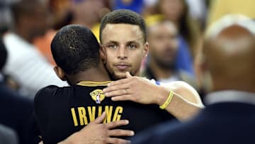Jun 19, 2016; Oakland, CA, USA; Golden State Warriors guard Stephen Curry (30) and Cleveland Cavaliers guard Kyrie Irving (2) hug after game seven of the NBA Finals at Oracle Arena. Mandatory Credit: Bob Donnan-USA TODAY Sports