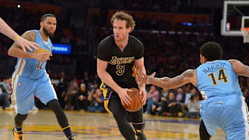 Mar 25, 2016; Los Angeles, CA, USA; Los Angeles Lakers guard Marcelo Huertas (9) dribbles the ball between Denver Nuggets guard Gary Harris (14) and guard D.J. Augustin (12) in the second half of the game at Staples Center. Nuggets won 116-105. Mandatory Credit: Jayne Kamin-Oncea-USA TODAY Sports